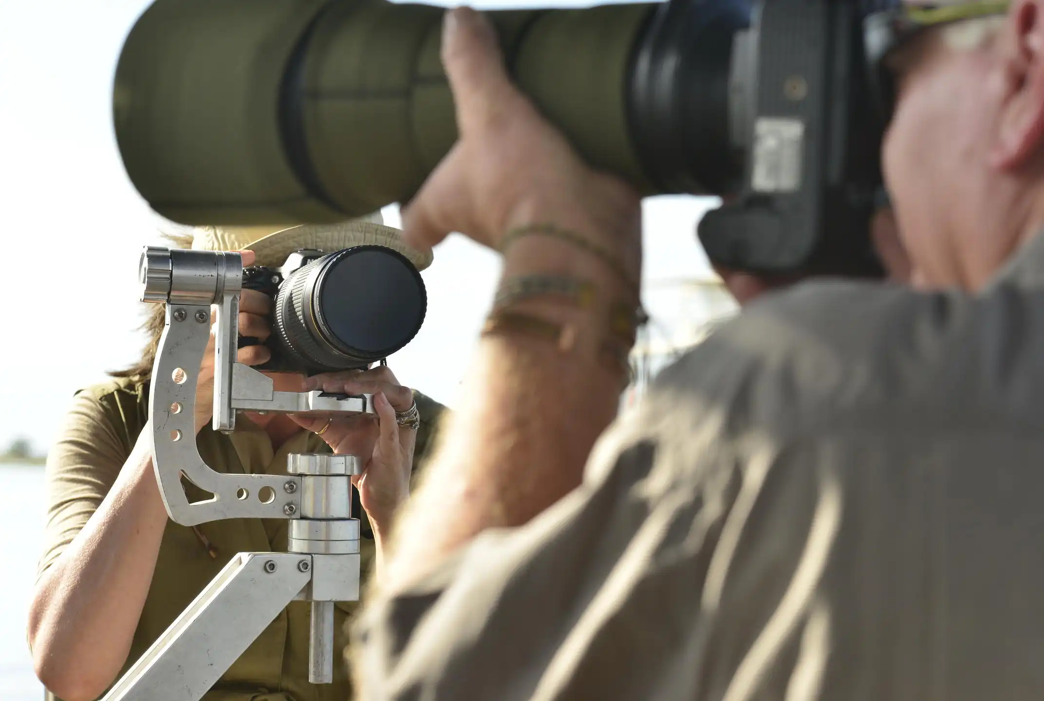 African photo safari: Photographers with large lenses capturing wildlife on an African safari.