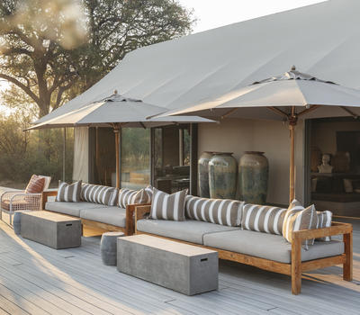 Camp Hwange: Luxury safari tent with outdoor lounge. African safari photo.