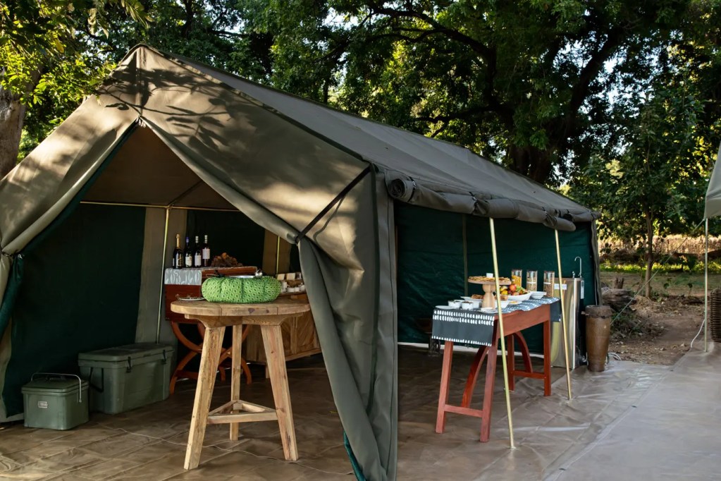 Luxury tent at an African safari camp with refreshments. Photo safari preparation.