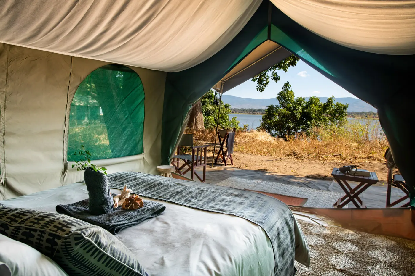 Luxury safari tent interior with lake view. African safari photo safari experience.