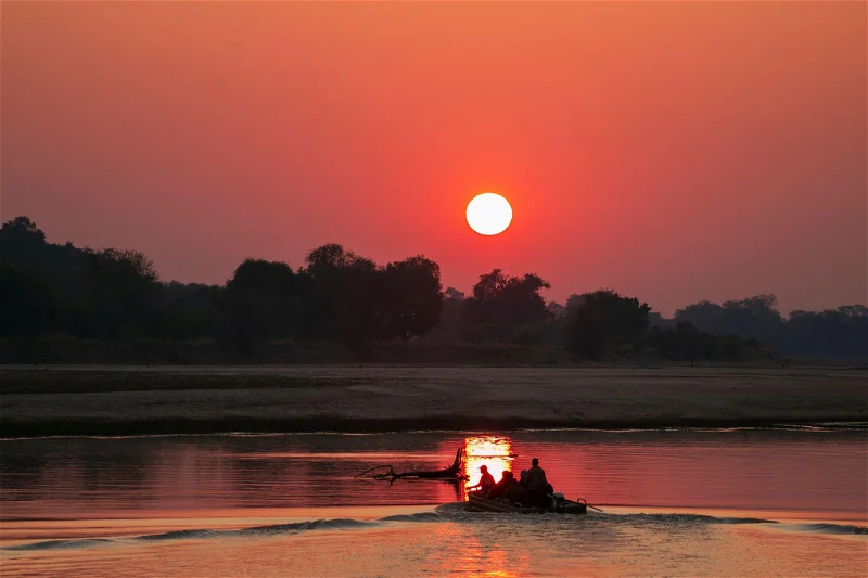 African photo safari at sunset on South Luangwa River, Zambia.