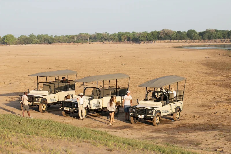 South Luangwa photo safari: Safari vehicles and tourists prepare for an African safari adventure.