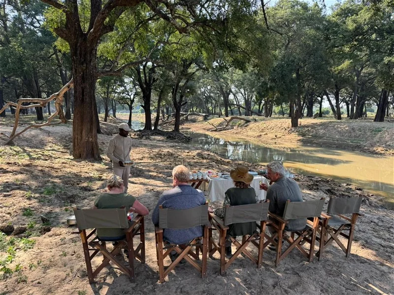 South Luangwa photo safari: Group enjoys riverside refreshment break during African safari.