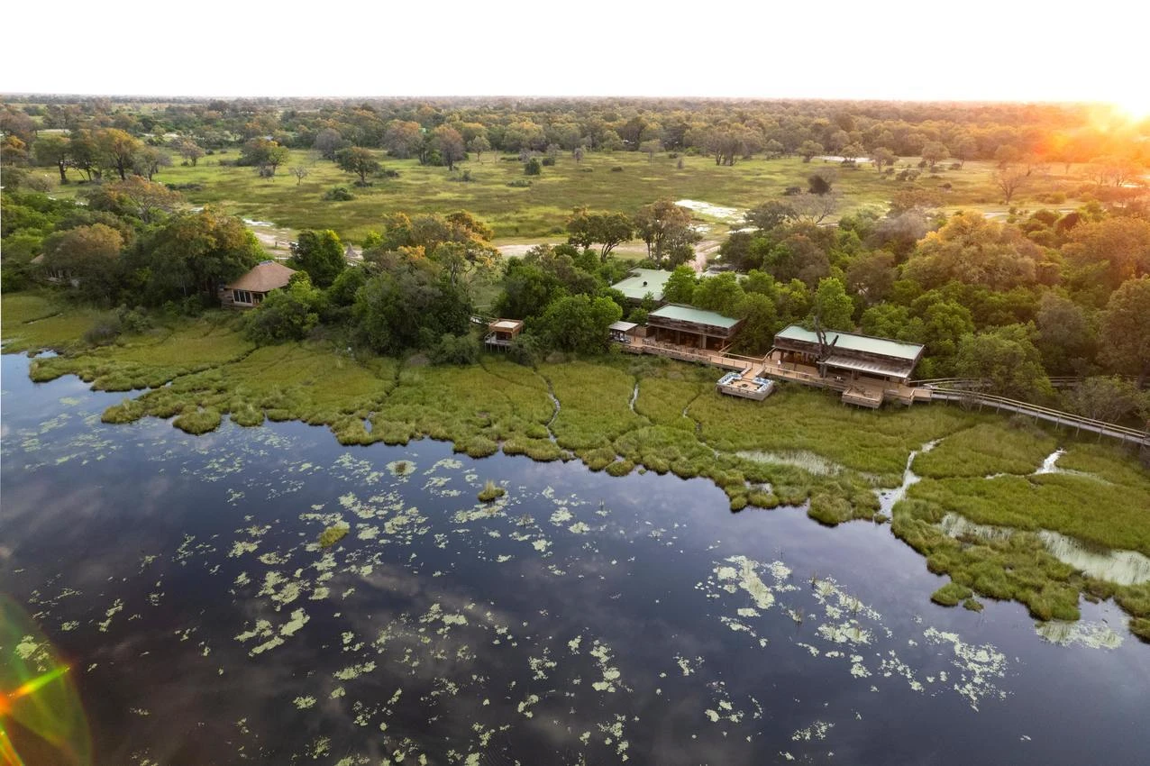 African photo safari lodge on the Okavango Delta, Botswana. Lush landscape with river views.
