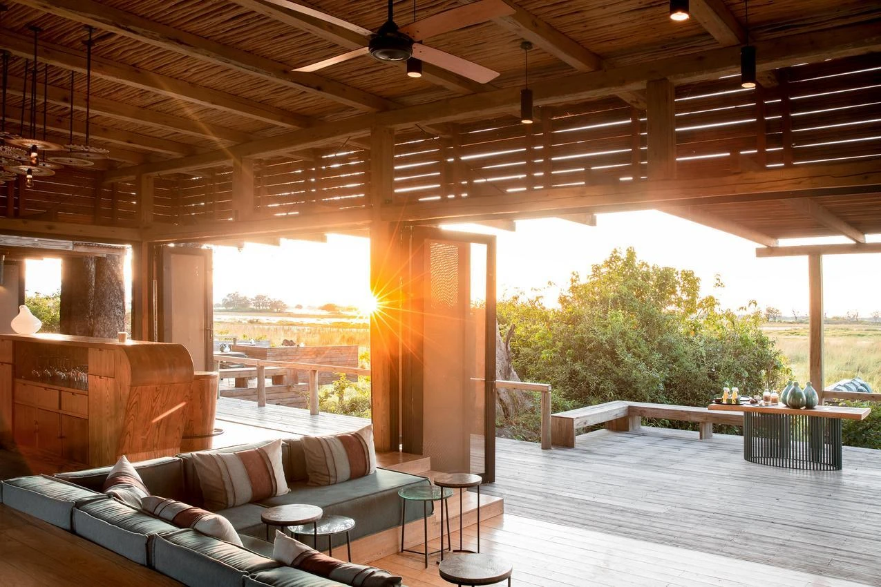 Luxurious safari lodge interior with open deck at sunset, perfect for an African photo safari.