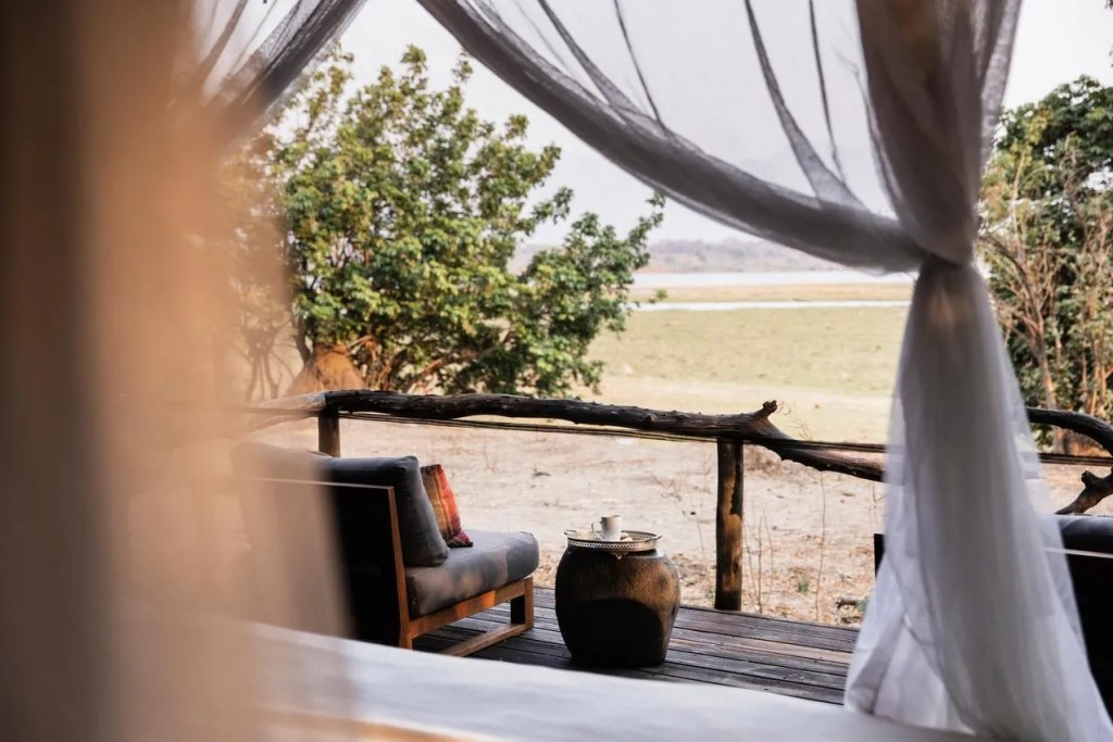 Luxury safari lodge deck with seating overlooking African landscape. Photo safari adventure.