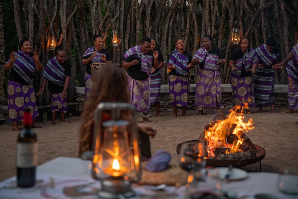 Uganda expedition: African women in traditional attire perform a dance during a photo safari.