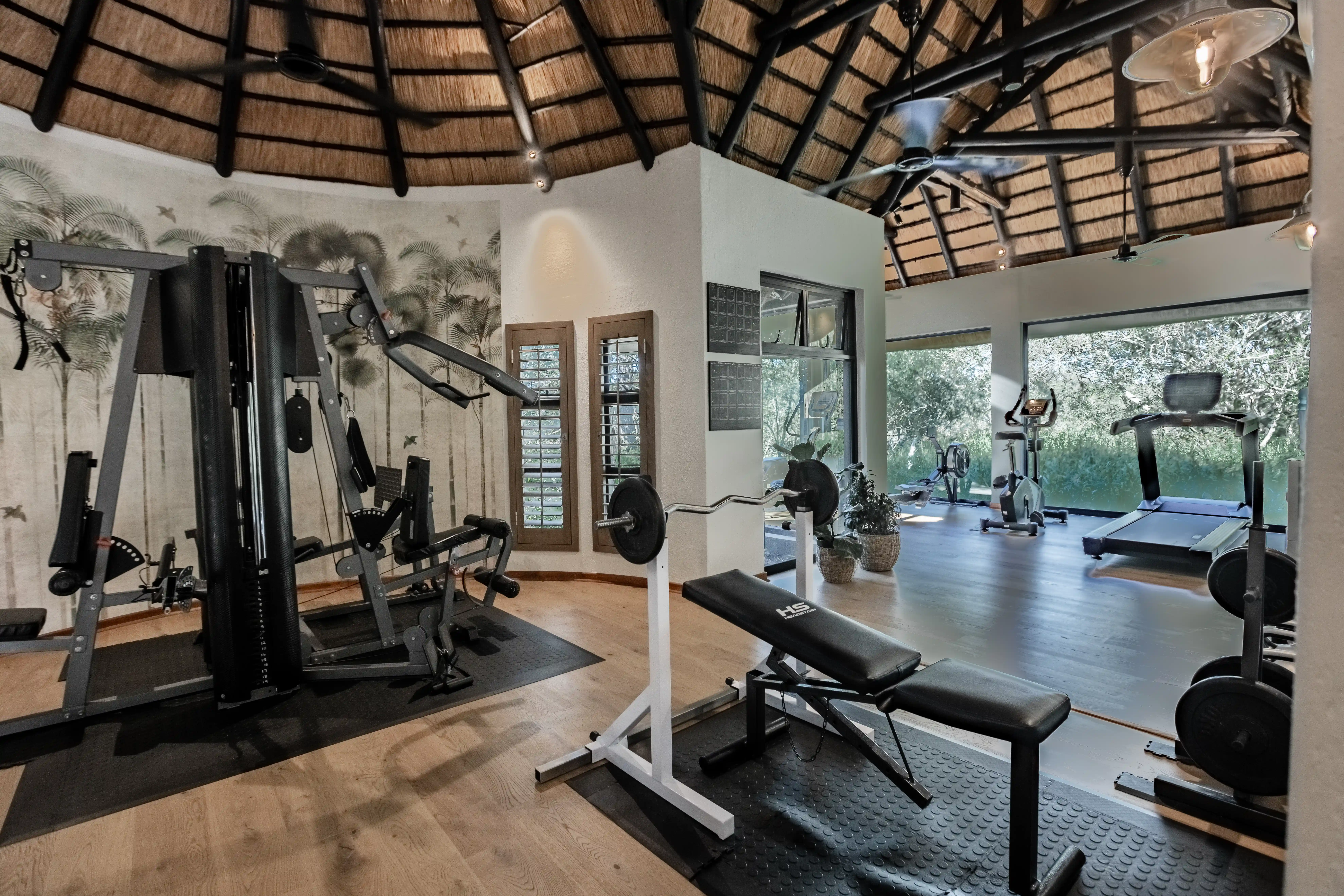Luxury gym at Sabi Sand photo safari lodge with safari-themed decor