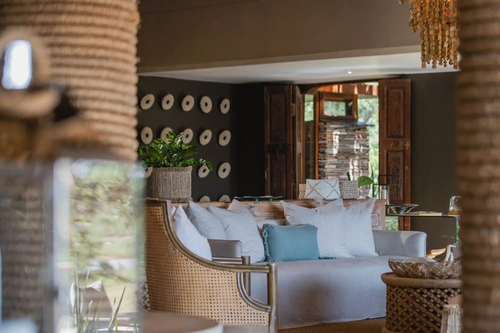 Luxury safari lodge living room with woven furniture, African photo safari decor