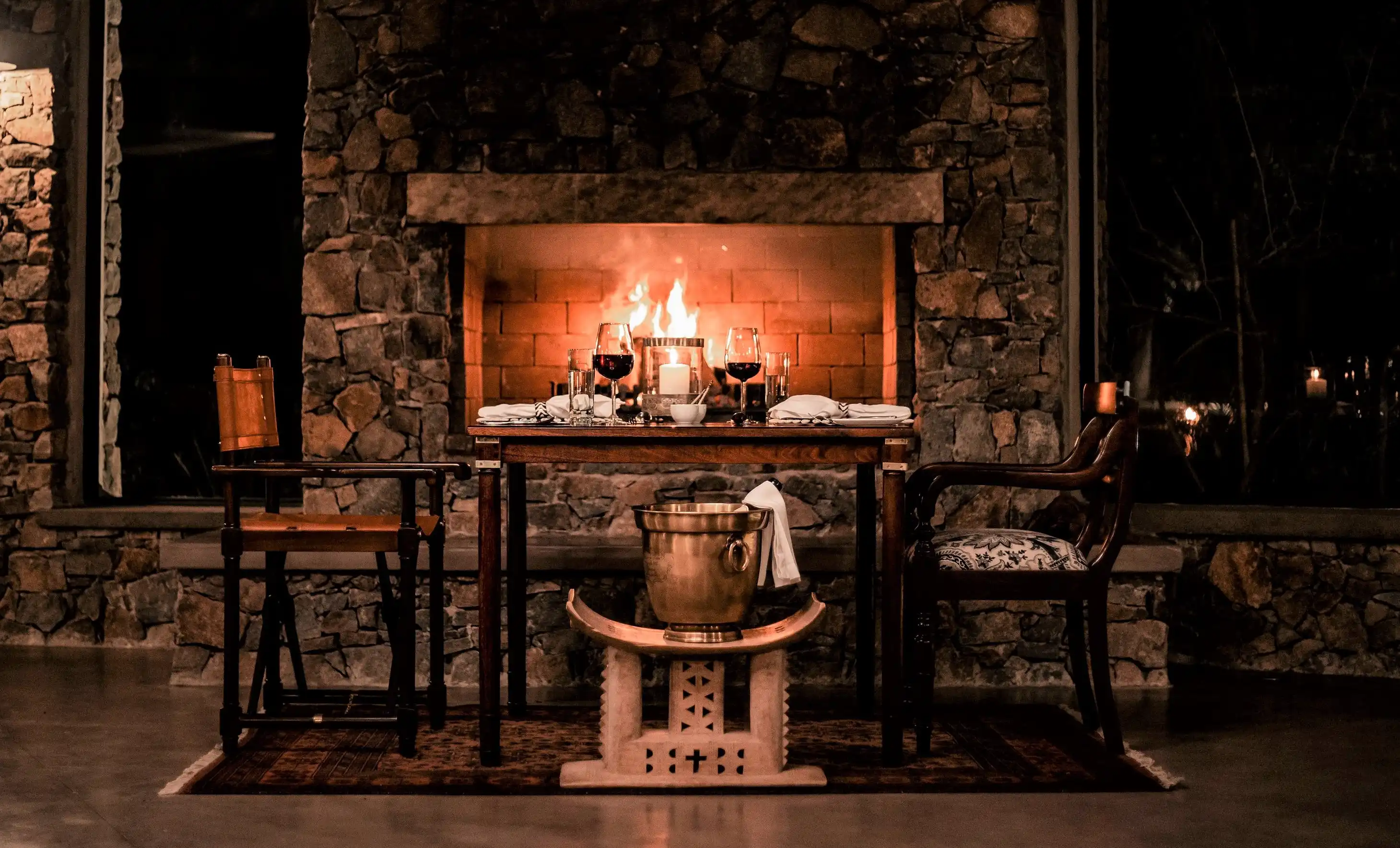 Romantic fireside dinner setting in Sabi Sand, South Africa, perfect for an African photo safari.