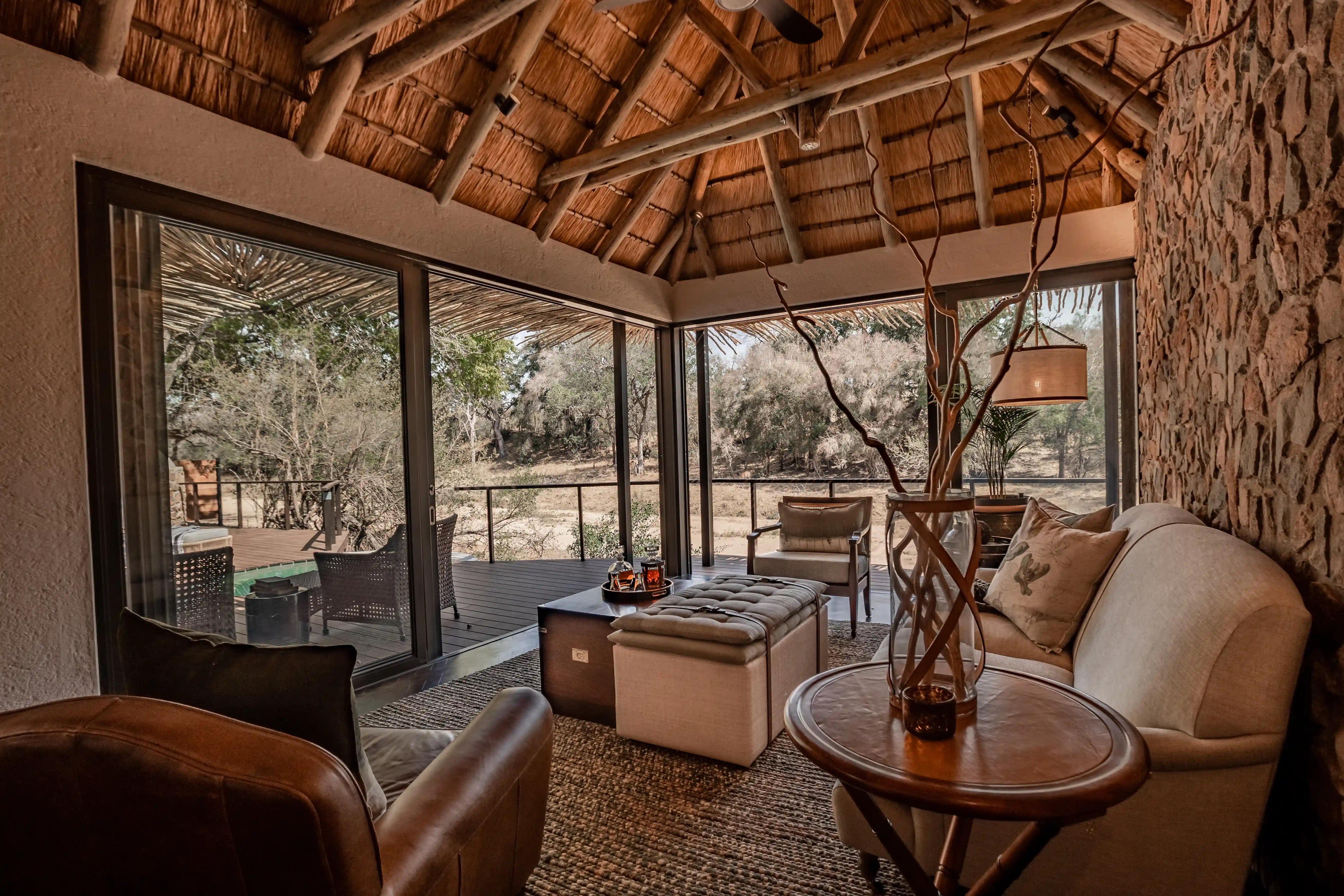 Luxury safari lodge interior with thatched roof and views of Sabi Sand