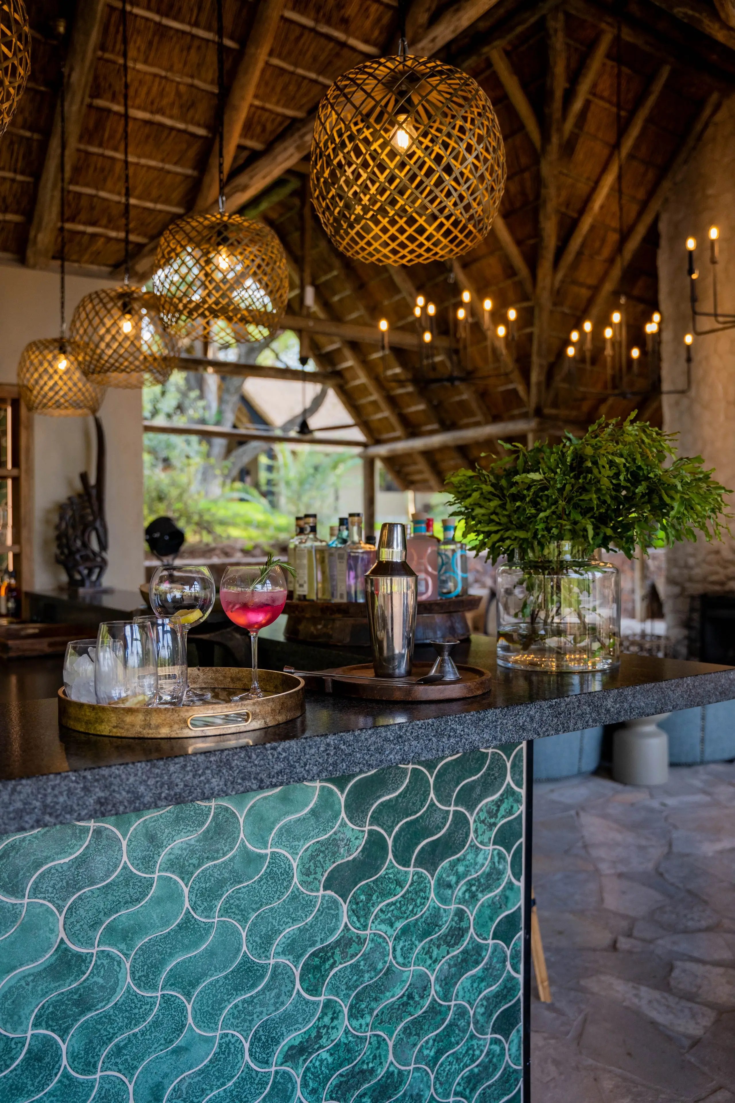 Luxury bar with cocktails and gin bottles at Timbavuti, perfect for an African photo safari.