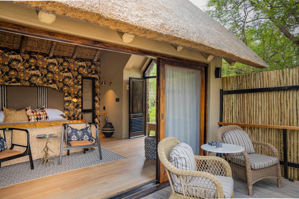 Luxury safari lodge bedroom with thatched roof, African safari photo