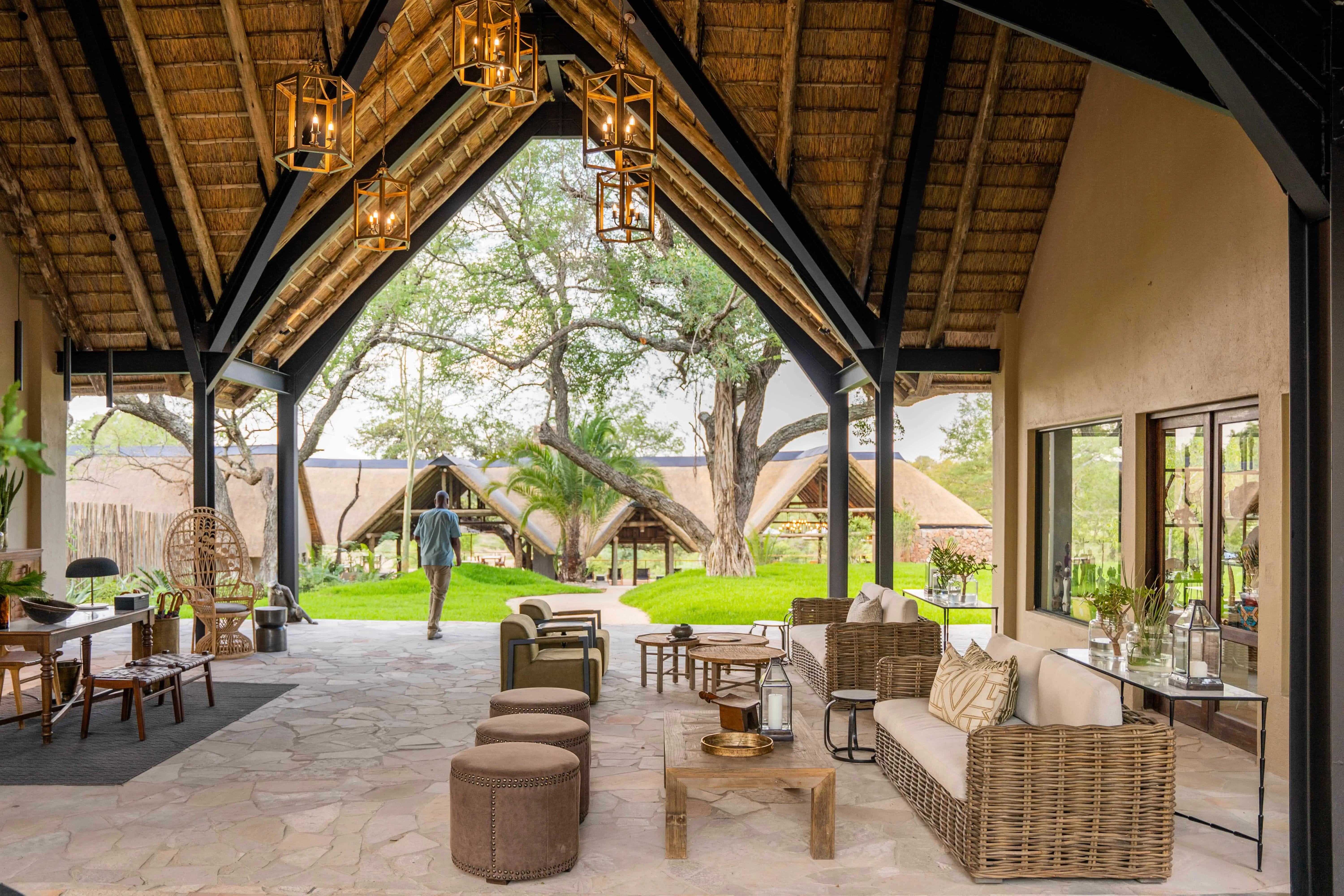 African safari lodge lounge with thatched roof, safari photo opportunities.