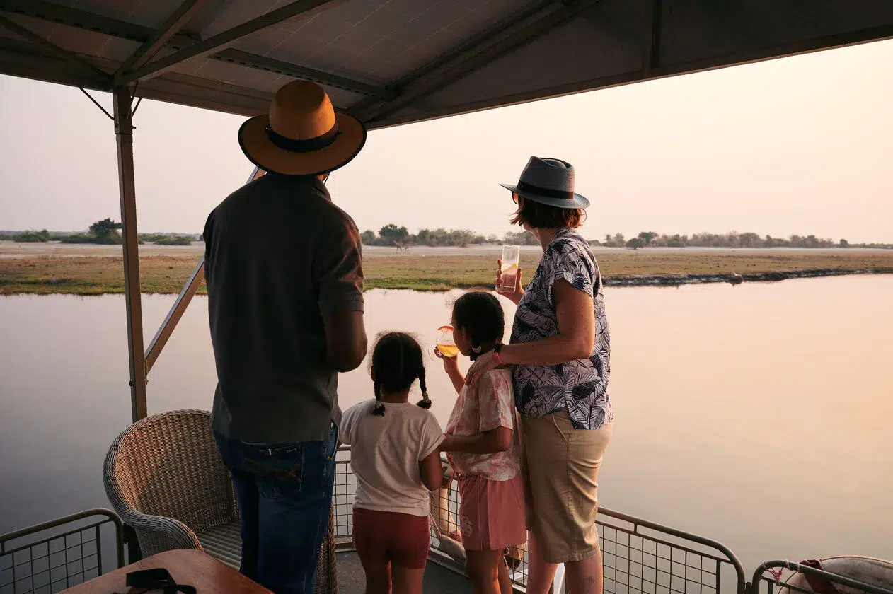 Family enjoying sunset on Chobe African safari photo safari boat