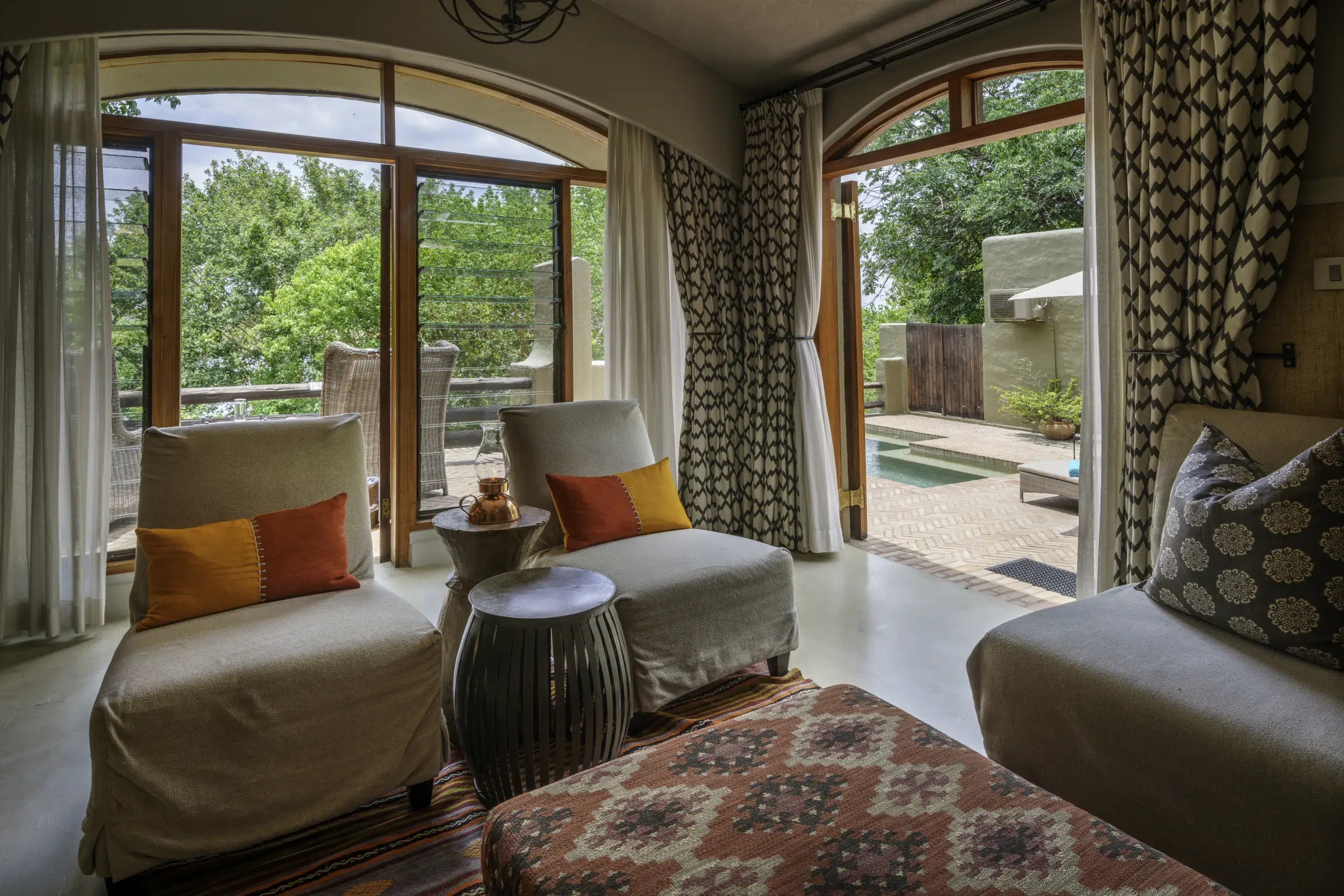 Chobe Signature 7nt: African safari lodge living room opens to pool