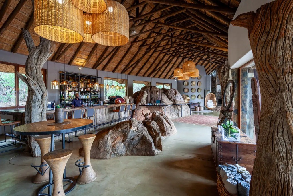 Wooden bar with stools in a Madikwe Signature lodge
