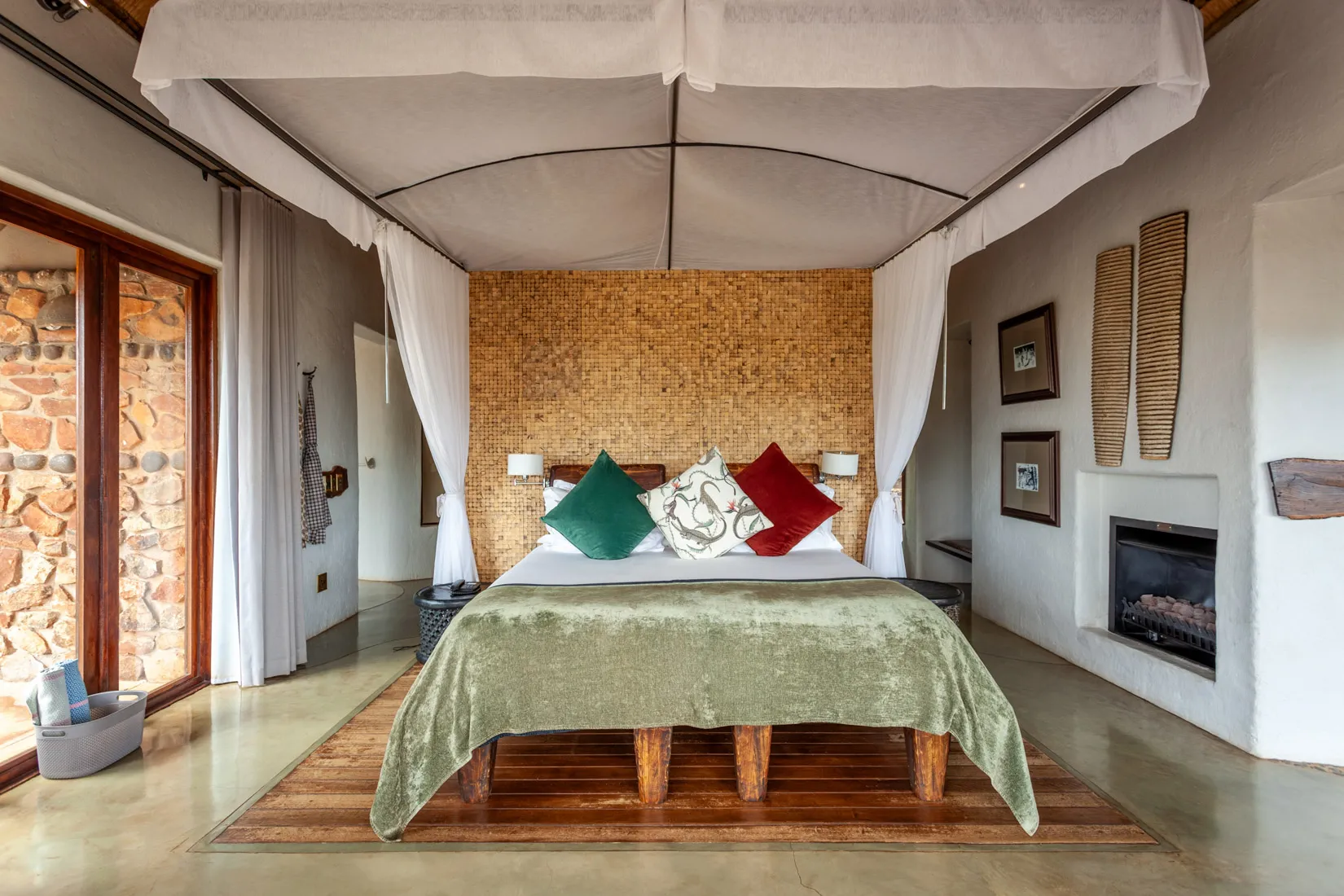 Luxury safari lodge bedroom with four-poster bed, African safari decor