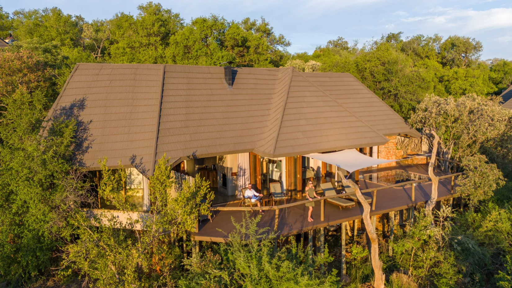 Luxury safari lodge deck with couple enjoying view in Madikwe, South Africa