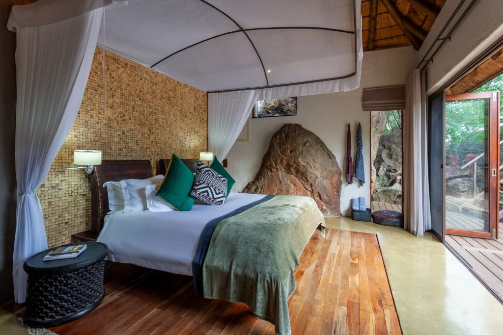 Luxury safari lodge bedroom with African safari decor, part of a photo safari experience.