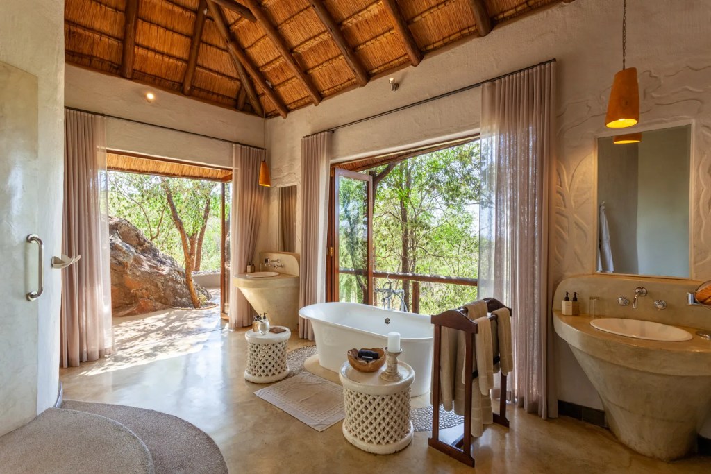Luxury safari bathroom with freestanding tub and nature view in Madikwe