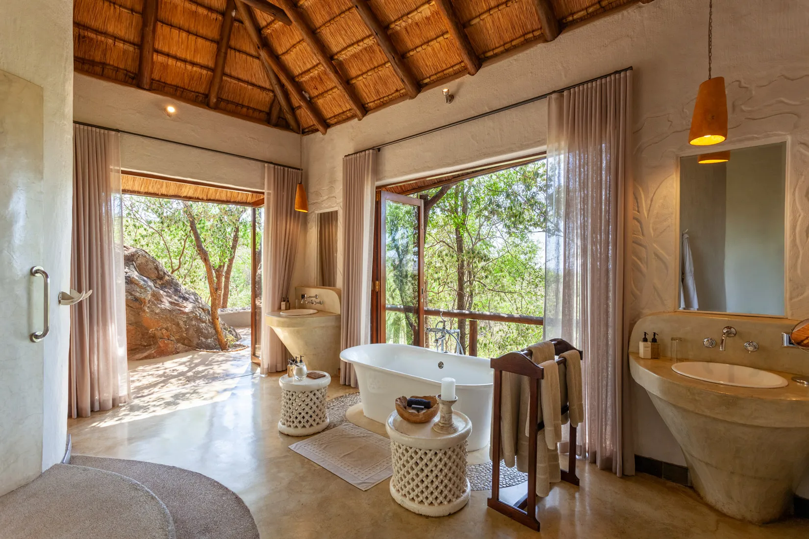 Luxury safari bathroom with freestanding tub and nature view in Madikwe